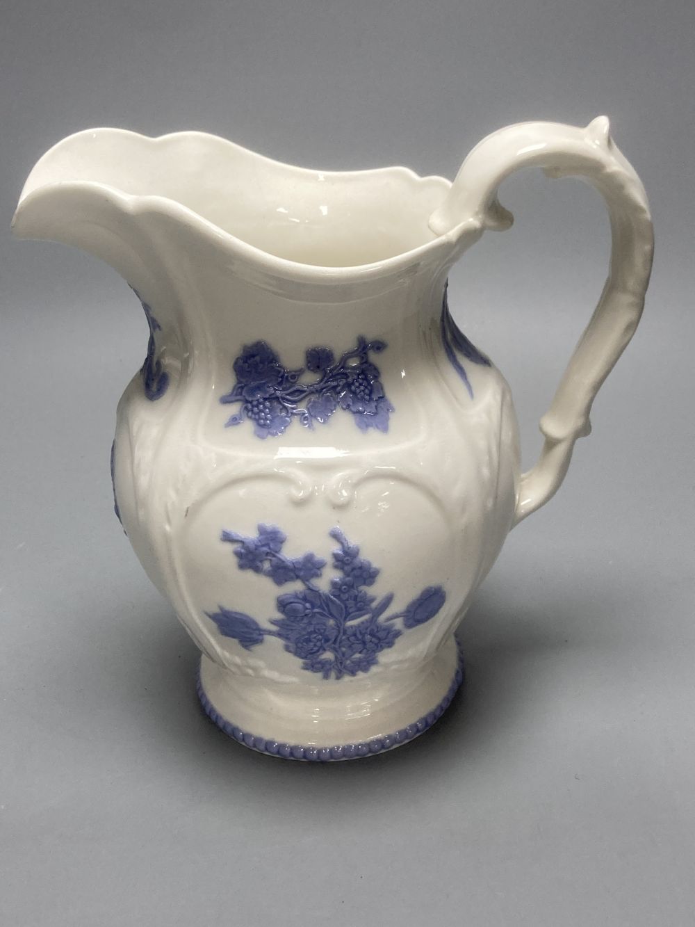 Four early 19th century Staffordshire jugs, each with lilac coloured floral applied panels, one dated 1826, tallest 22cm